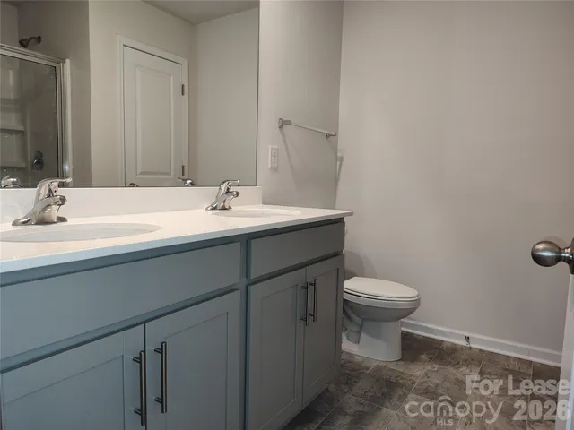 a bathroom with a sink toilet and mirror