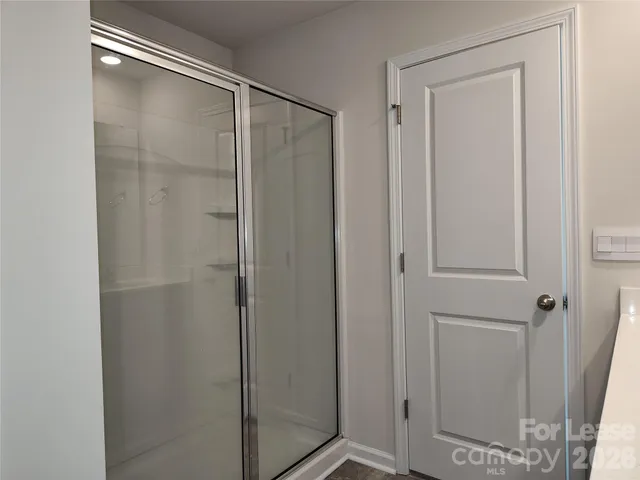 a bathroom with a glass shower door