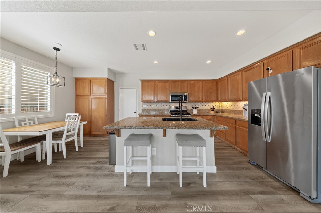 32985 Novara Court Temecula, CA 92592 - Photo 23 of 56 Large Kitchen With Center Island, Ample Cabinetry, And Breakfast Area