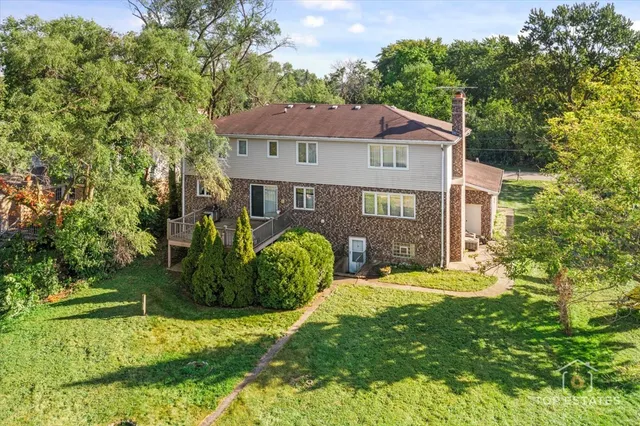 a view of a wooden house with a yard