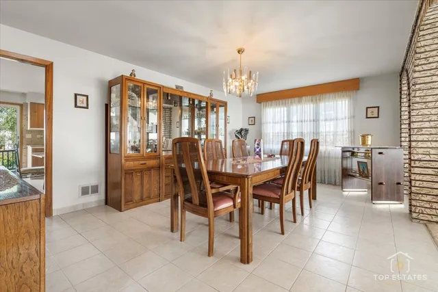 a view of a dining room with furniture and window