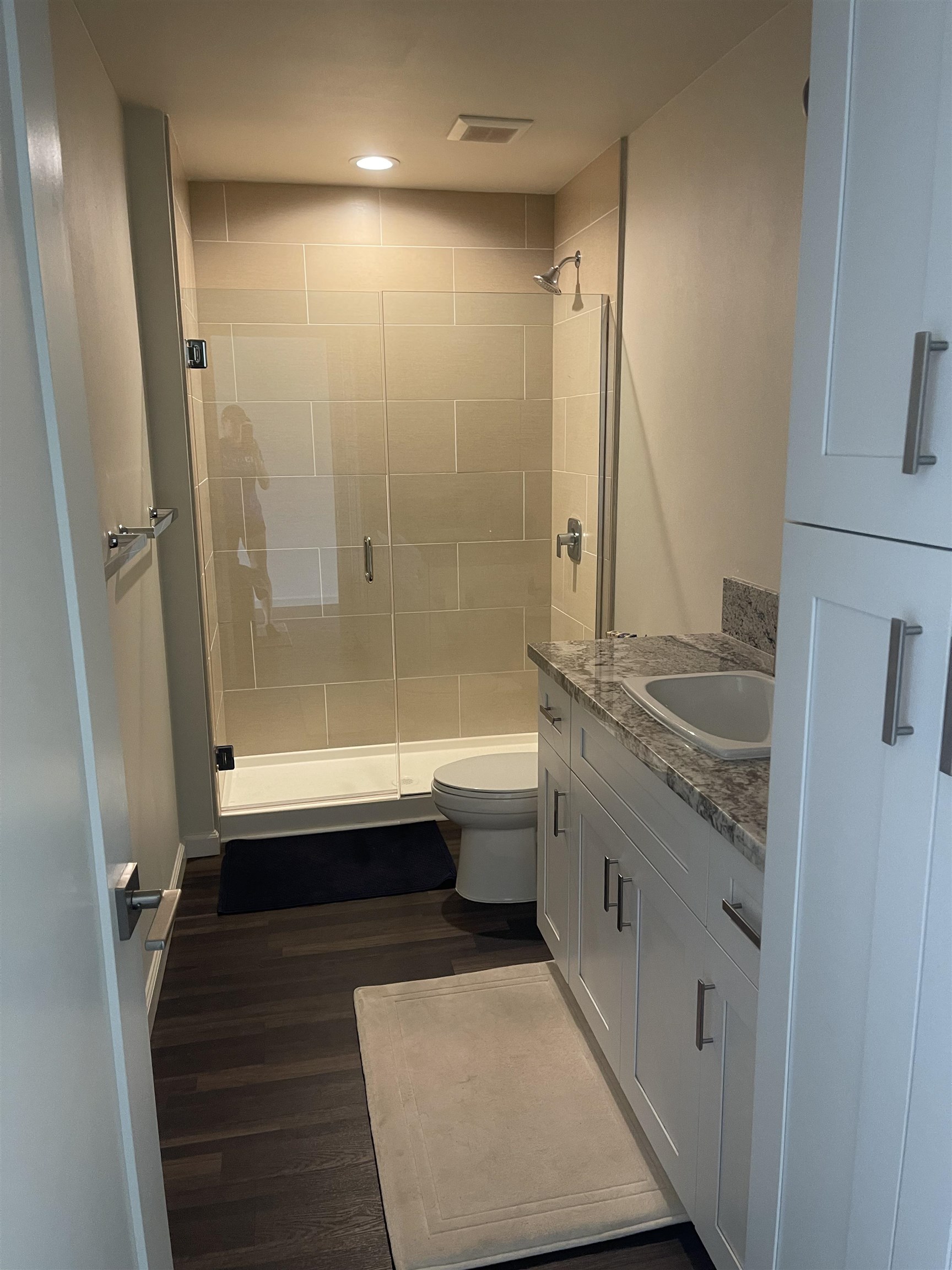 5510 Lower Honoapiilani Road, Unit C22 Lahaina, HI 96761 - Photo 3 of 13 a bathroom with a granite countertop sink a toilet and shower
