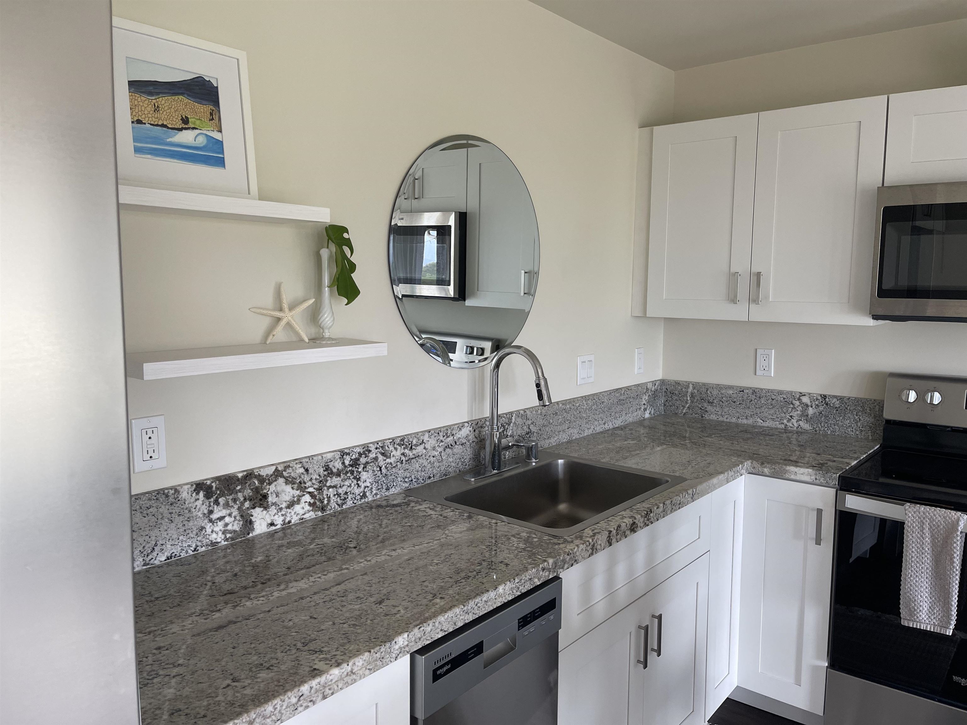 5510 Lower Honoapiilani Road, Unit C22 Lahaina, HI 96761 - Photo 4 of 13 a kitchen with a sink a stove and cabinets