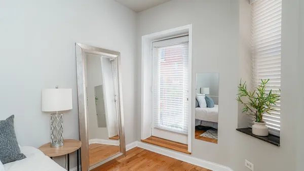 a bathroom with a granite countertop sink toilet a mirror and shower