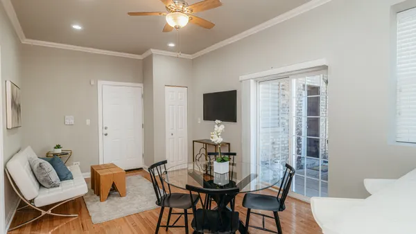 a kitchen with a table chairs refrigerator and microwave