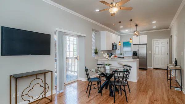 a view of a dining room with furniture and wooden floor