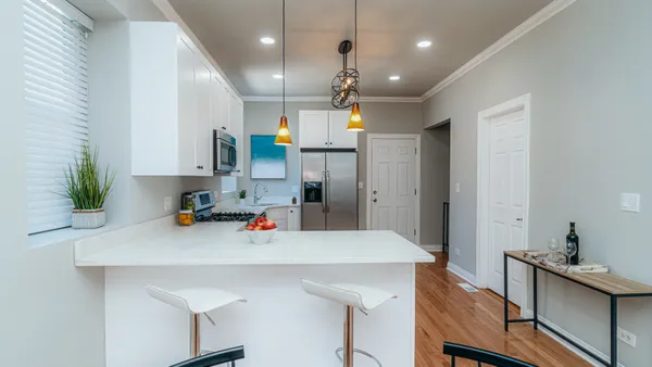 a kitchen that has a lot of counter space and wooden floor