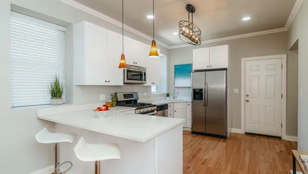 a kitchen with stainless steel appliances granite countertop a stove a refrigerator and a microwave