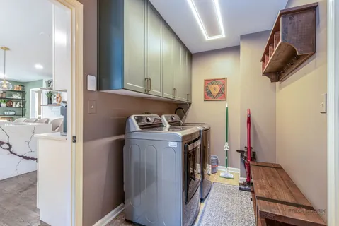 a view of a storage & utility room with two washing machine