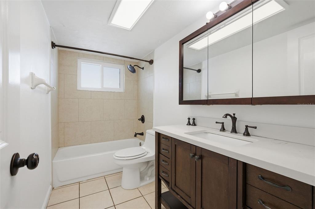4536 Webber Street Sarasota, FL 34232 - Photo 25 of 45 a bathroom with a tub a sink and mirror