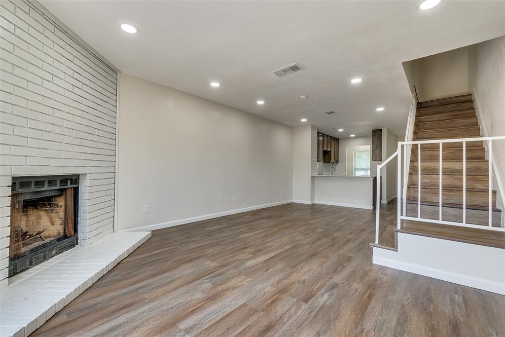 709 Lee Street, Unit 3 Mesquite, TX 75149 - Photo 2 of 9 a view of empty room with wooden floor and fireplace