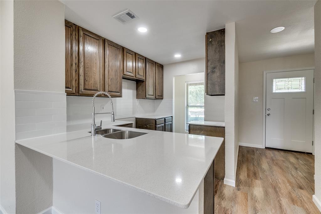 709 Lee Street, Unit 3 Mesquite, TX 75149 - Photo 3 of 9 a kitchen with stainless steel appliances granite countertop a sink a stove and a refrigerator