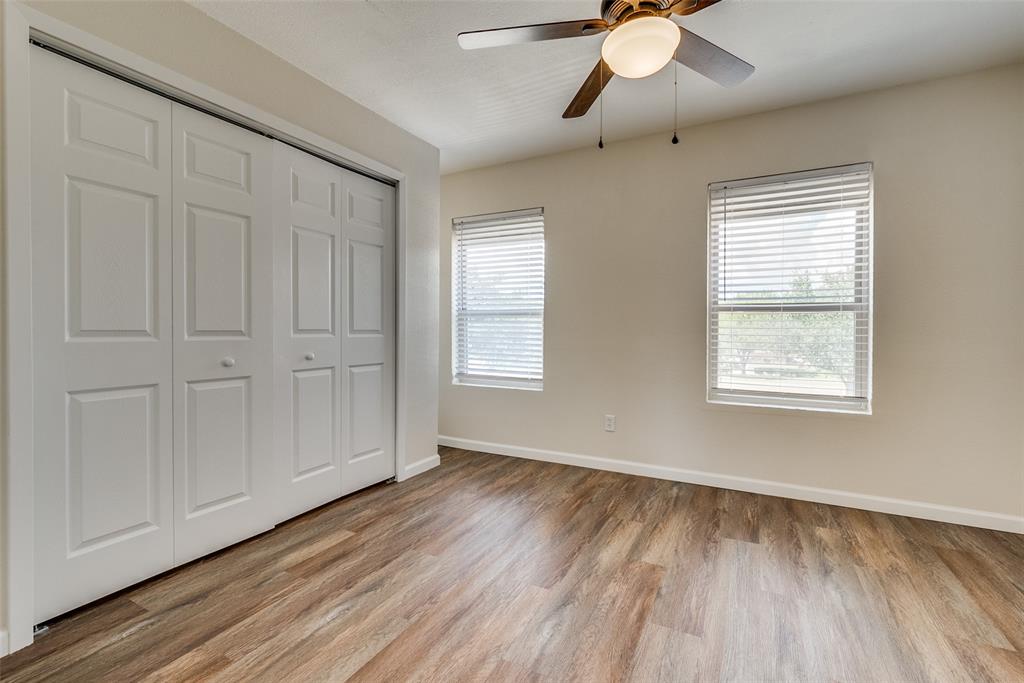 709 Lee Street, Unit 3 Mesquite, TX 75149 - Photo 7 of 9 a view of an empty room with window and wooden floor