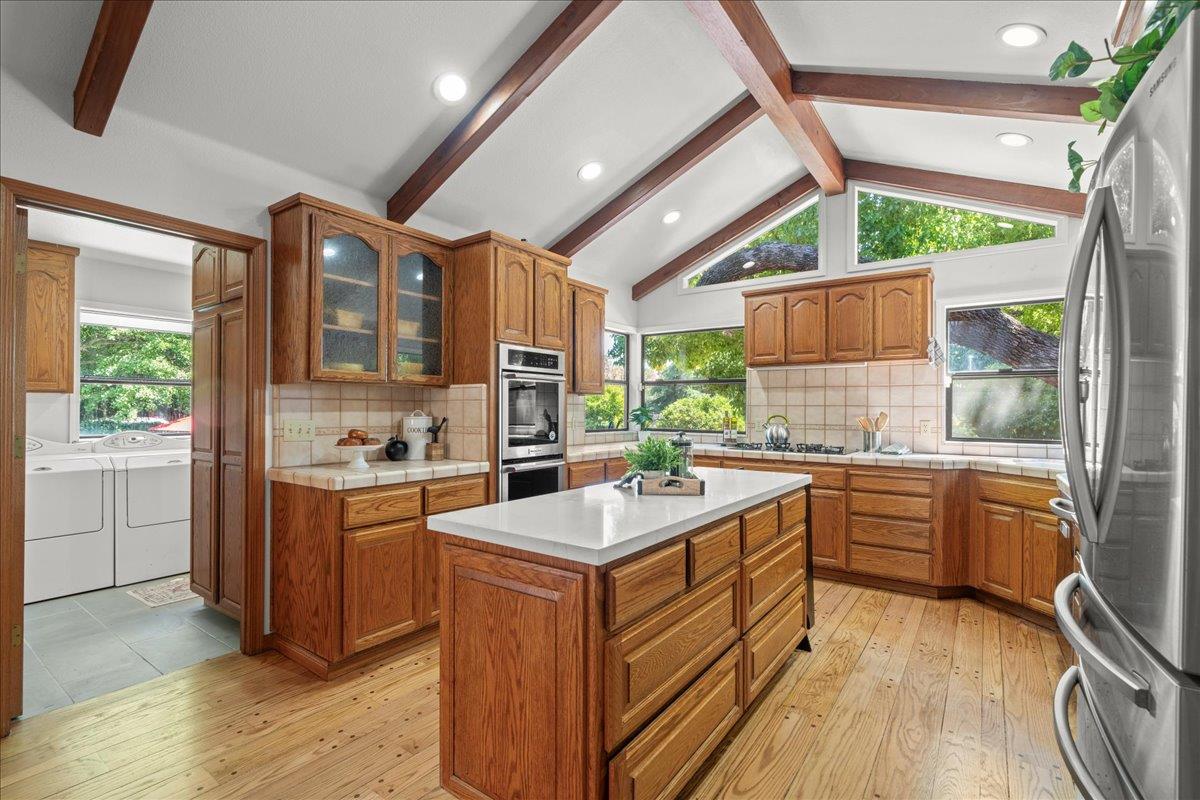 14325 Monterey Road Morgan Hill, CA 95037 - Photo 12 of 41 a kitchen with wooden cabinets and white appliances