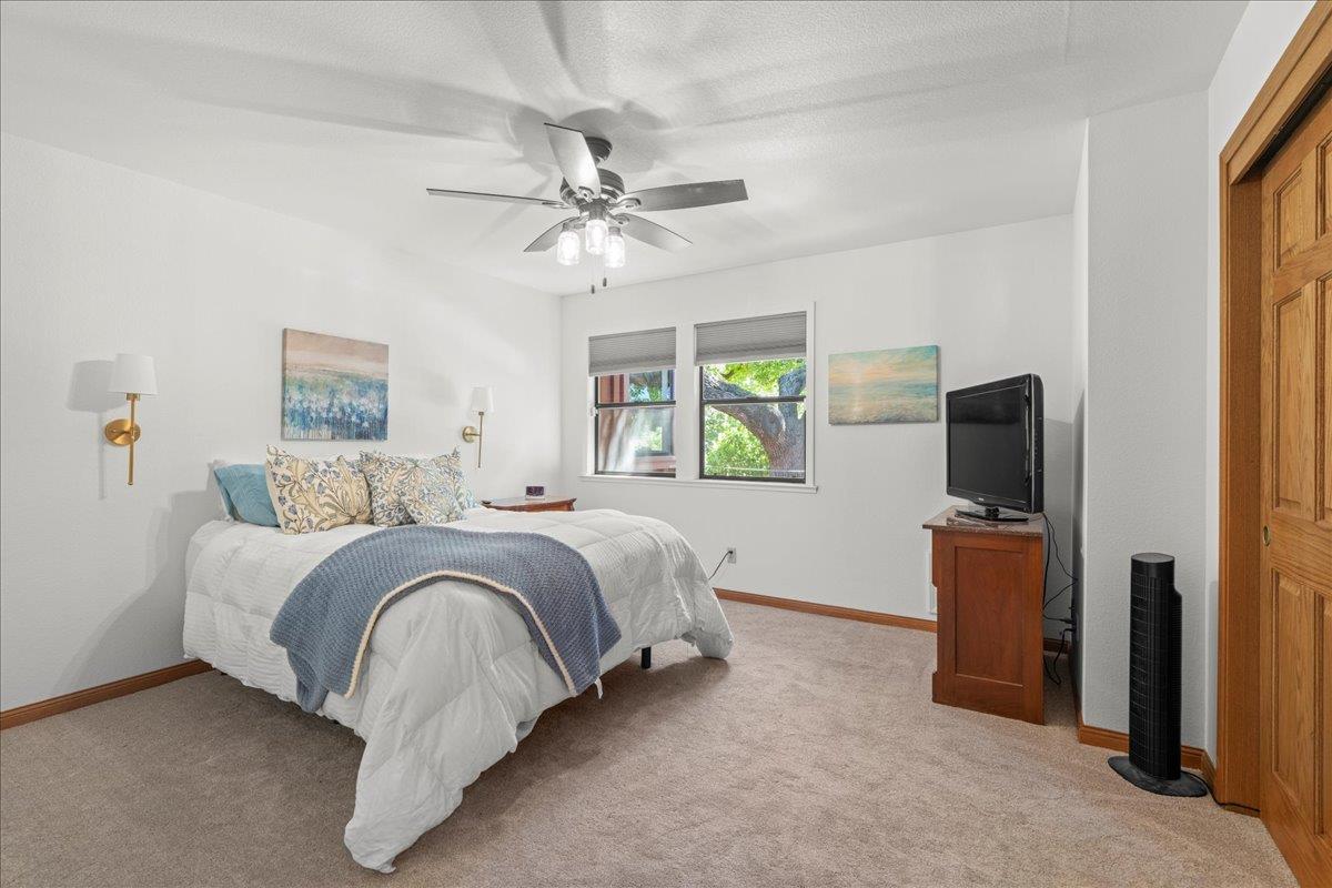 14325 Monterey Road Morgan Hill, CA 95037 - Photo 17 of 41 a spacious bedroom with a bed and a flat screen tv