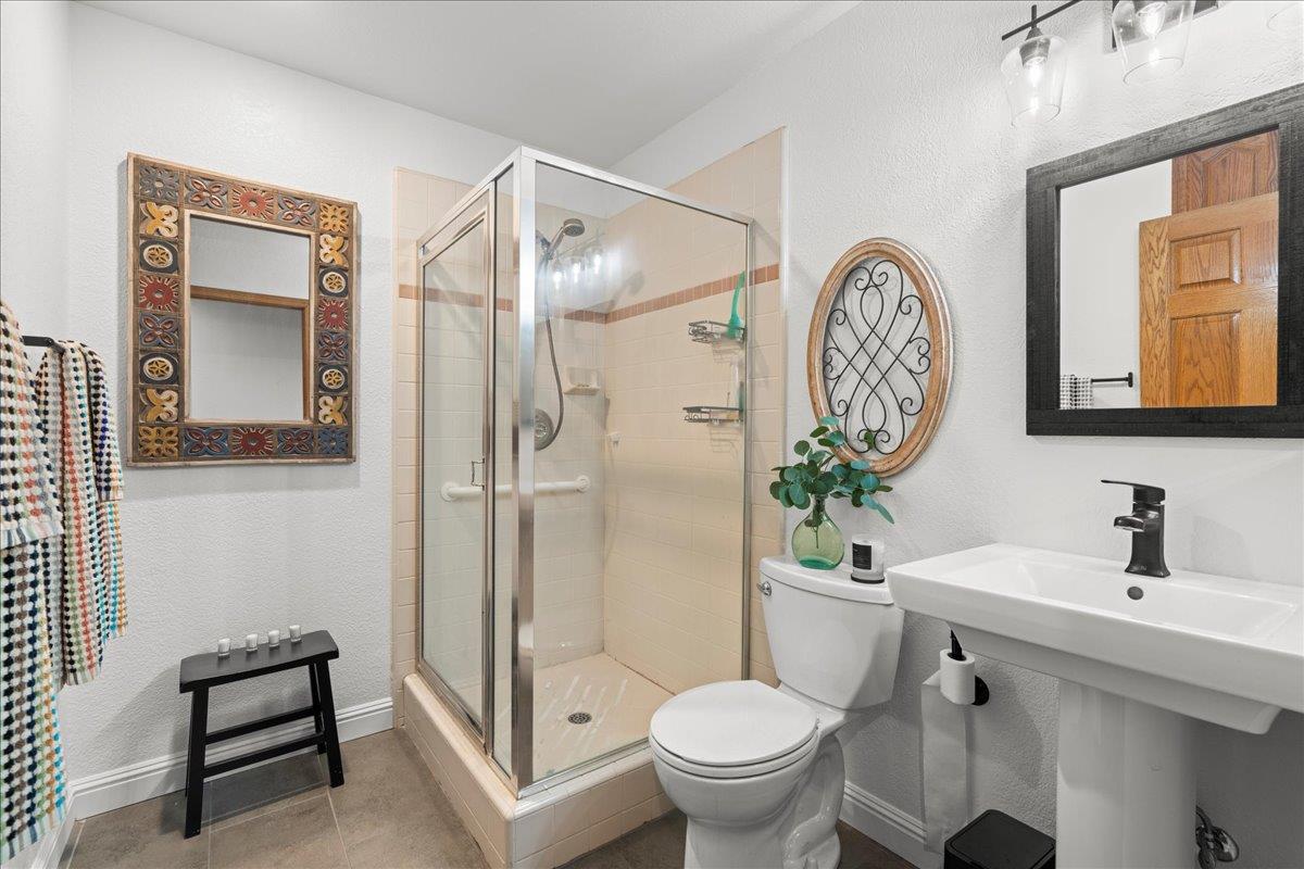 14325 Monterey Road Morgan Hill, CA 95037 - Photo 20 of 41 a bathroom with a toilet a sink and a mirror