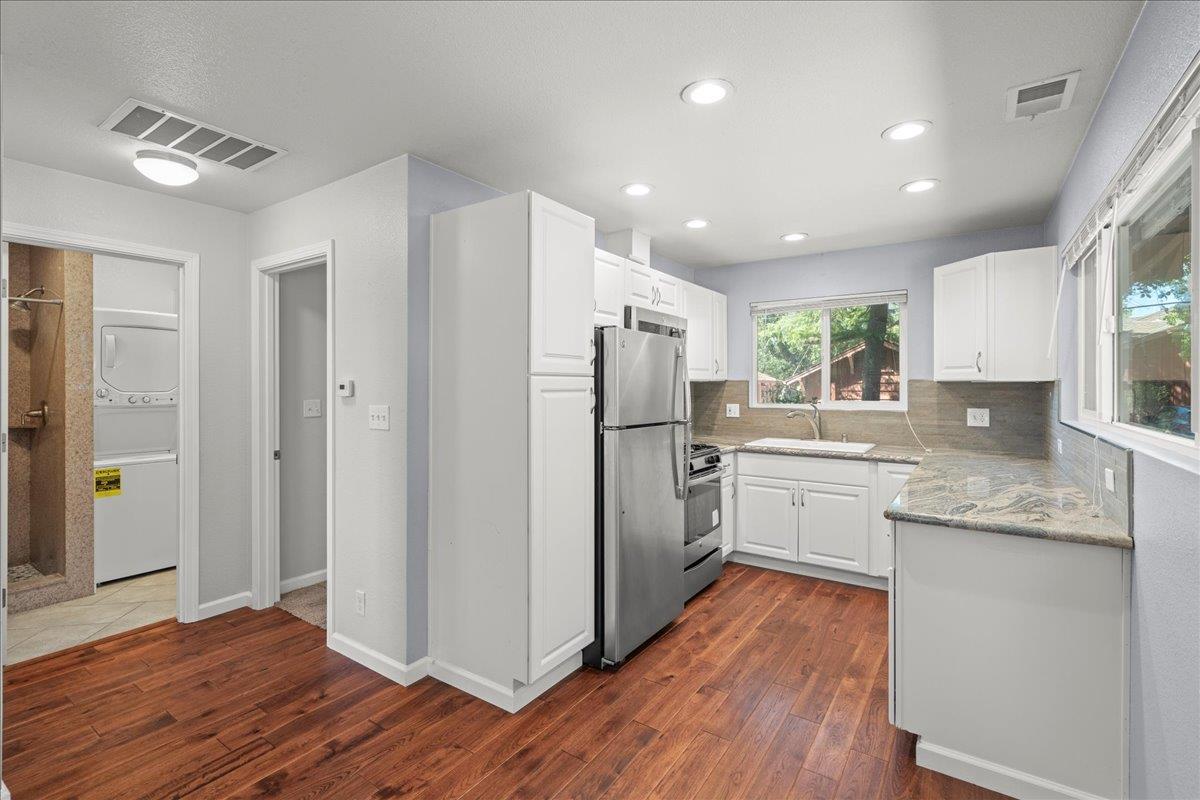 14325 Monterey Road Morgan Hill, CA 95037 - Photo 25 of 41 a kitchen with kitchen island wooden floors appliances and cabinets