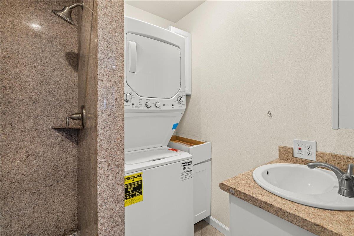 14325 Monterey Road Morgan Hill, CA 95037 - Photo 29 of 41 a bathroom with a granite countertop sink a mirror and a shower