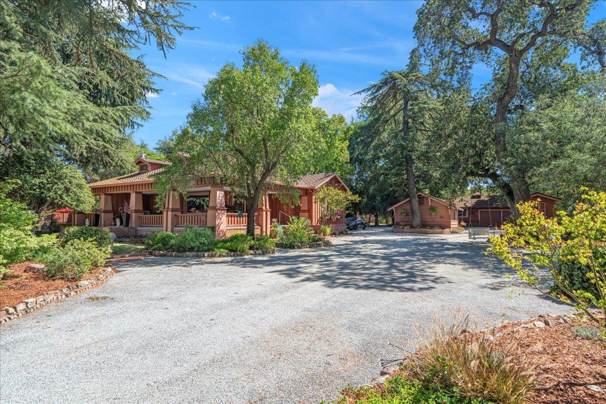 14325 Monterey Road Morgan Hill, CA 95037 - Photo 5 of 41 a front view of a house with a yard and a garage