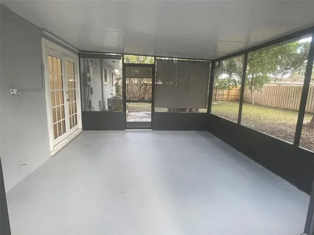 a view of an empty room with windows and a balcony