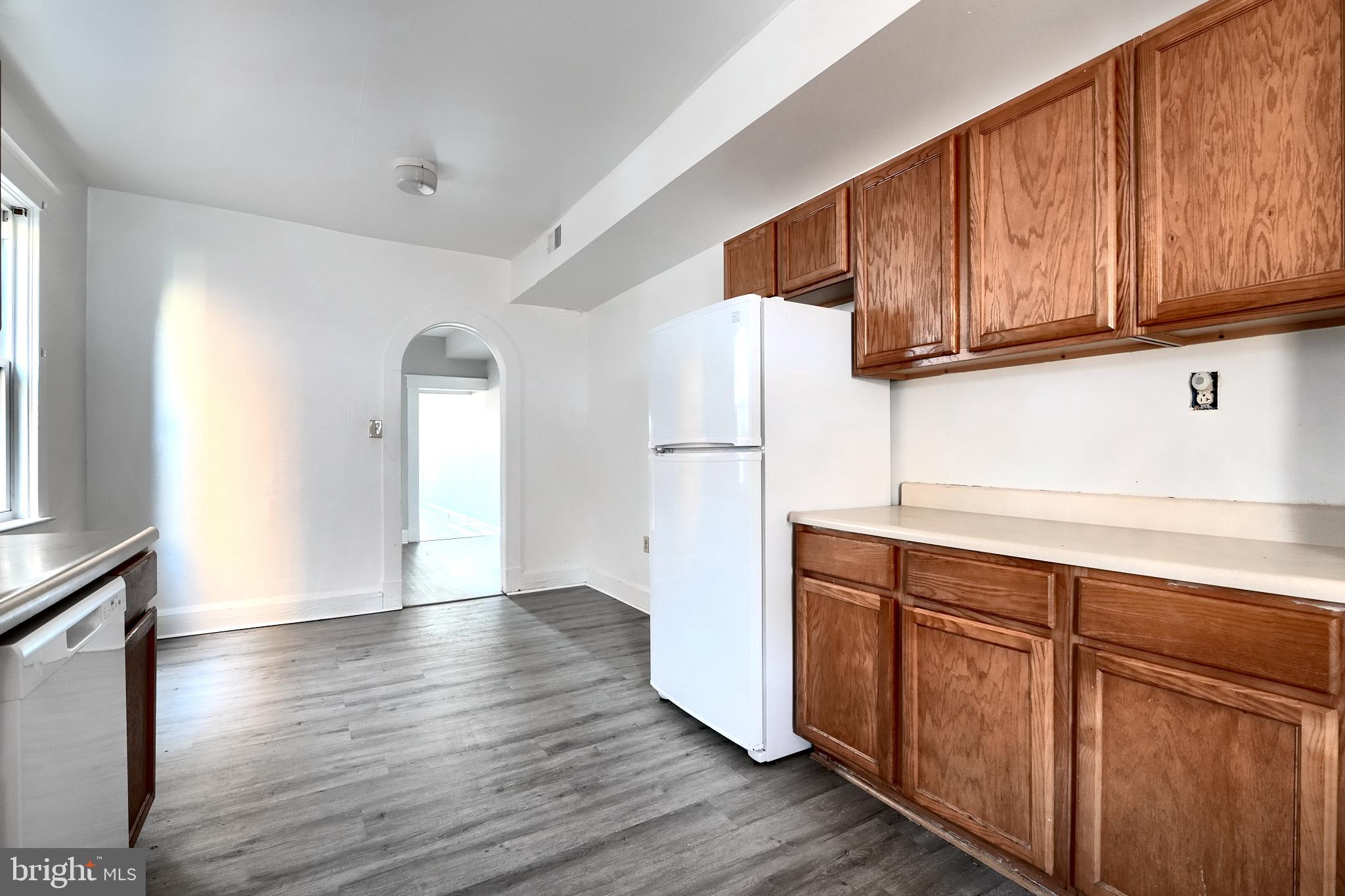5106 Harford Road Baltimore, MD 21214 - Photo 14 of 23 a view of cabinets with wooden floor and electronic appliances