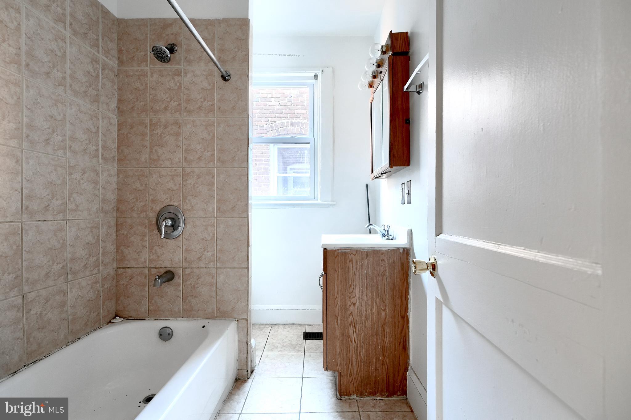 5106 Harford Road Baltimore, MD 21214 - Photo 15 of 23 a bathroom with a bathtub and a shower