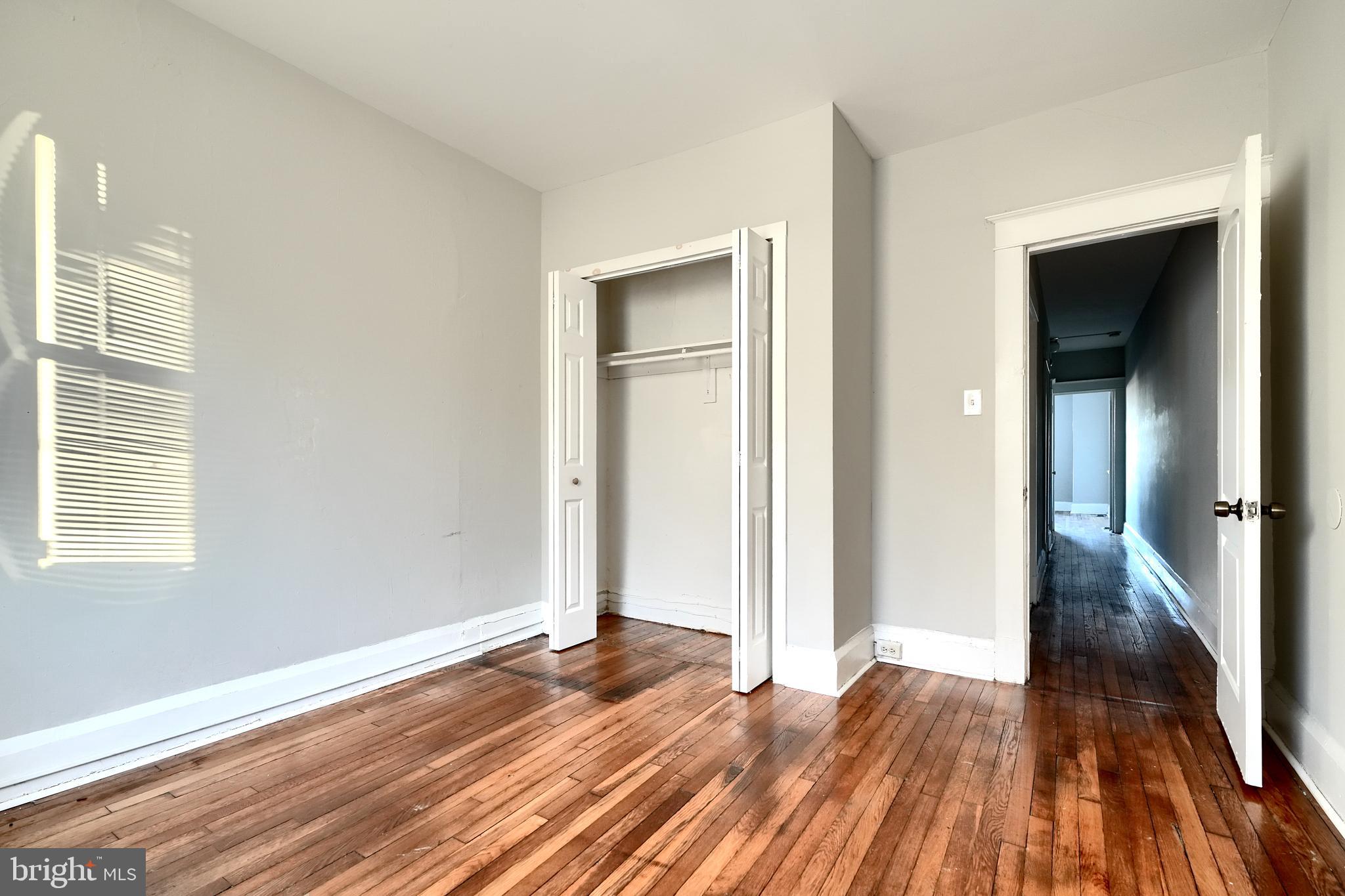 5106 Harford Road Baltimore, MD 21214 - Photo 18 of 23 a view of a room with wooden floor and window