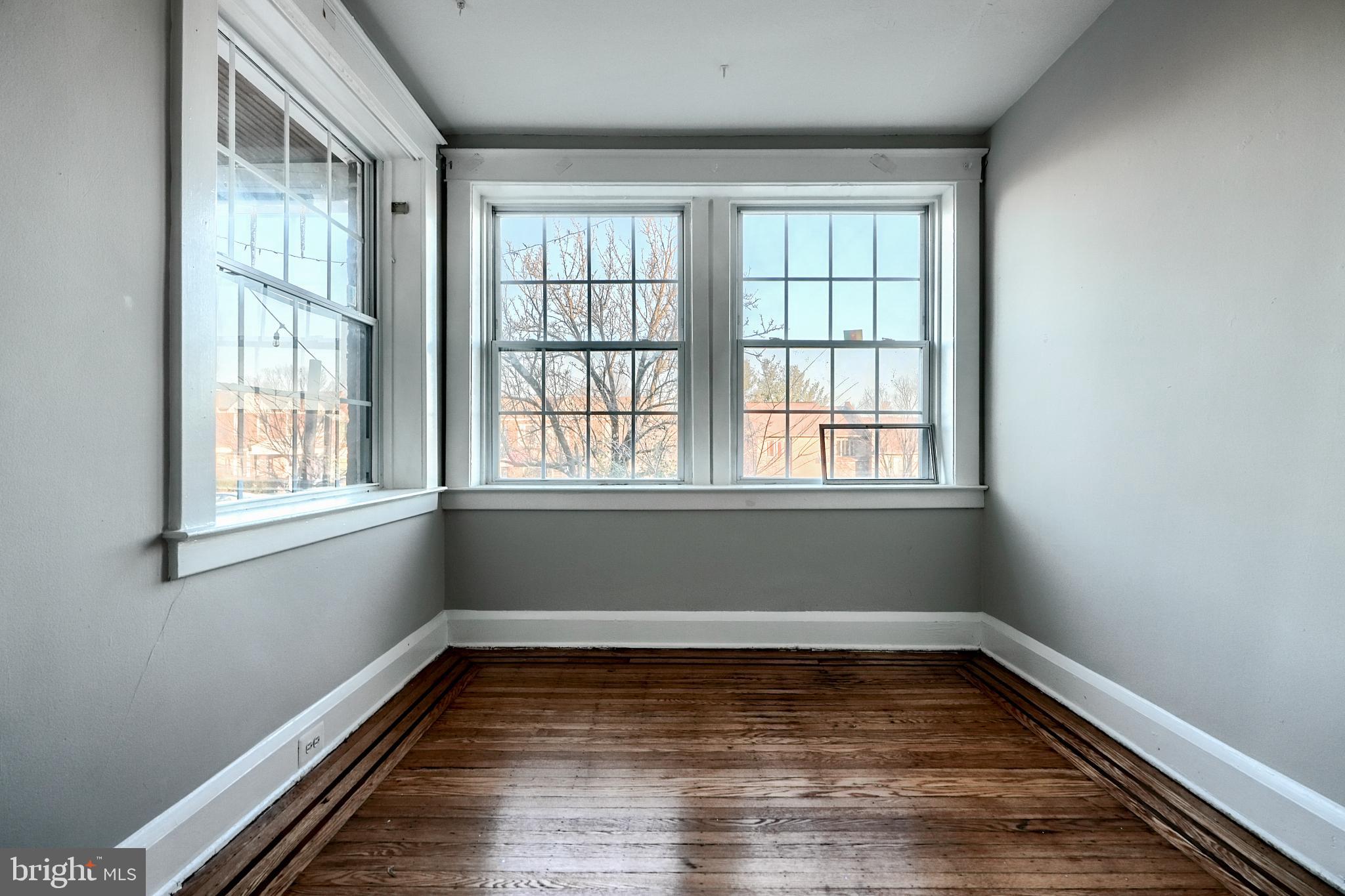5106 Harford Road Baltimore, MD 21214 - Photo 5 of 23 a view of a room with wooden floor and window