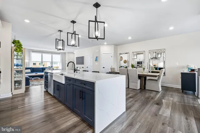 a kitchen with sink refrigerator and cabinets