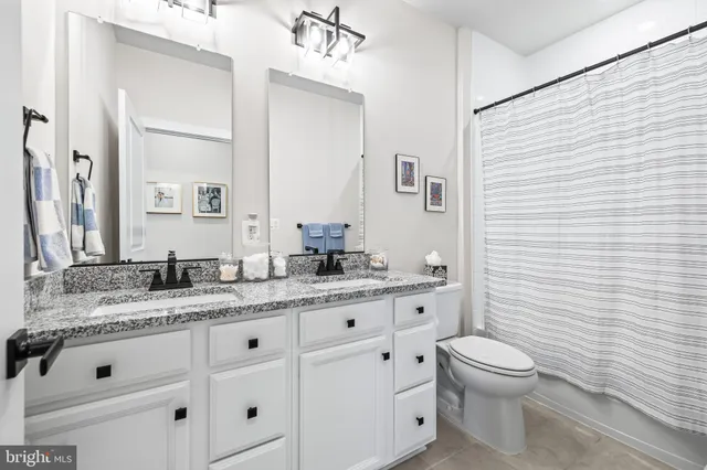 a spacious bedroom with a bed and a flat screen television