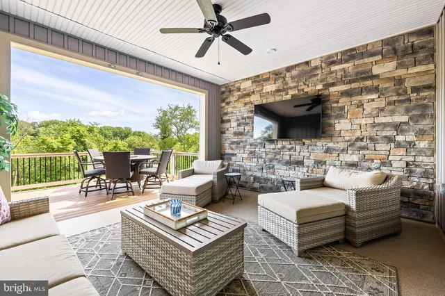 a living room with furniture a flat screen tv and a large window