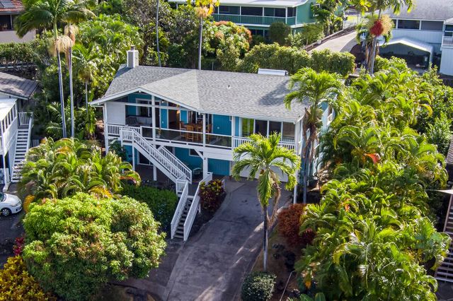 a aerial view of a house with a yard and garden