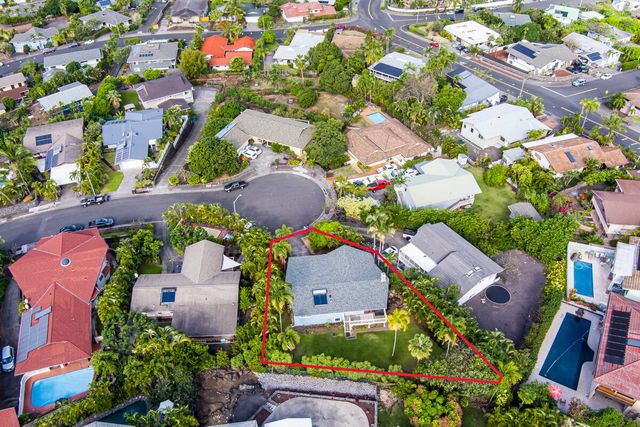 an aerial view of a house with a yard and lake view