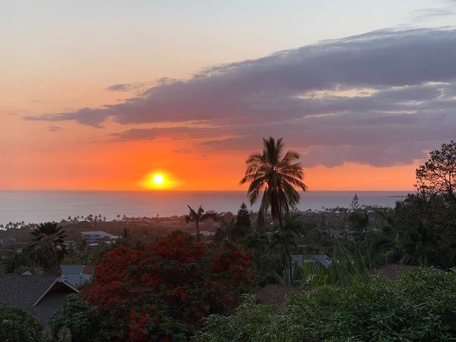 a dining room with furniture and a floor to ceiling window