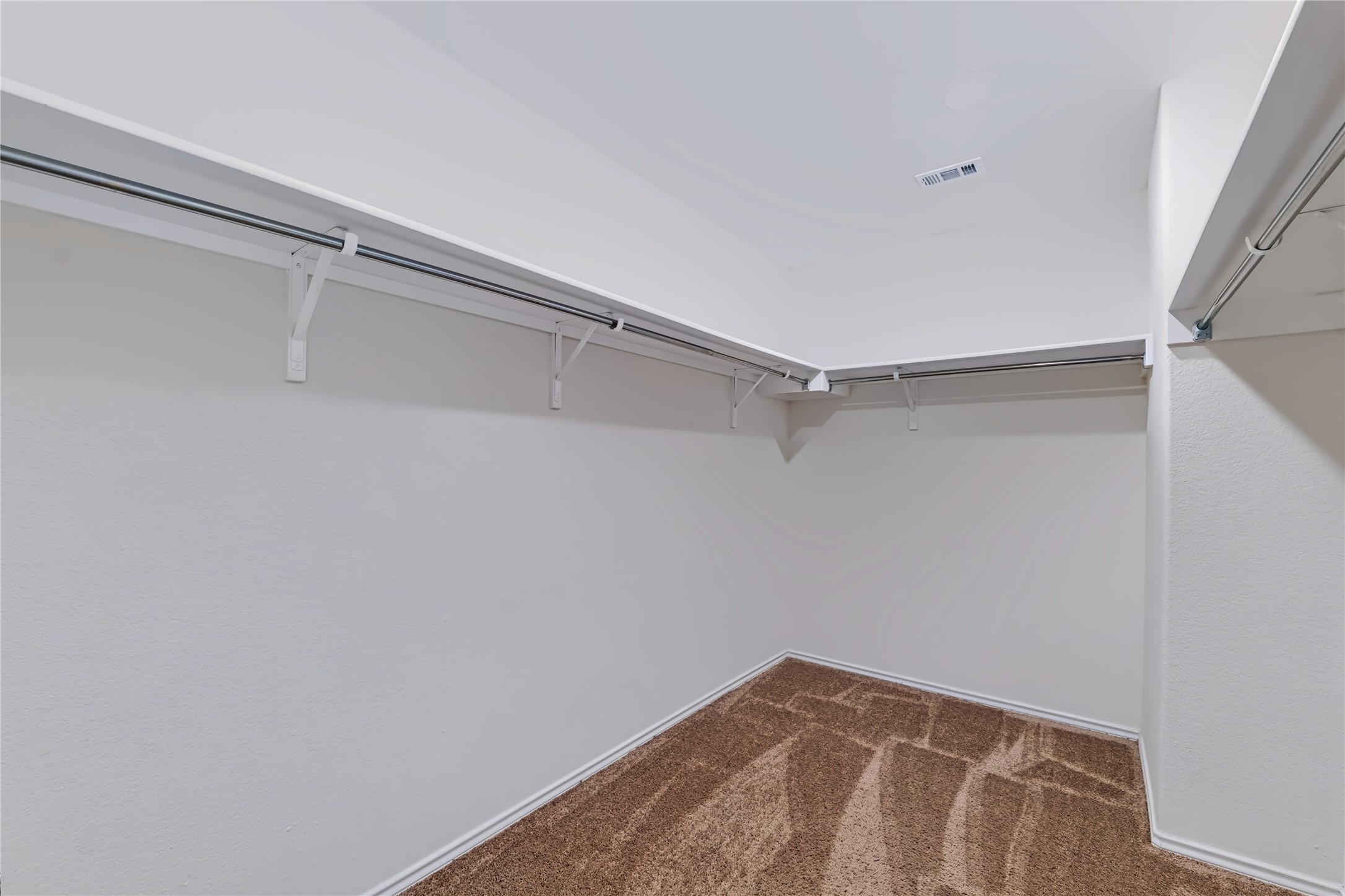 4600 Alfano Loop Round Rock, TX 78665 - Photo 19 of 34 Primary walk-in closet featuring extensive hanging space and overhead shelving.