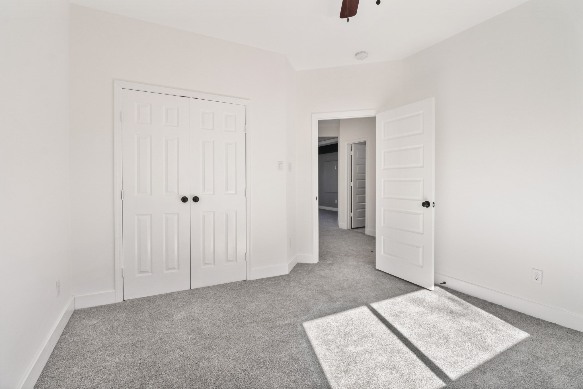 8046 Chateau Street Houston, TX 77028 - Photo 19 of 22 This bright, carpeted bedroom features neutral tones, ample natural light, a ceiling fan, and a spacious closet with double doors.