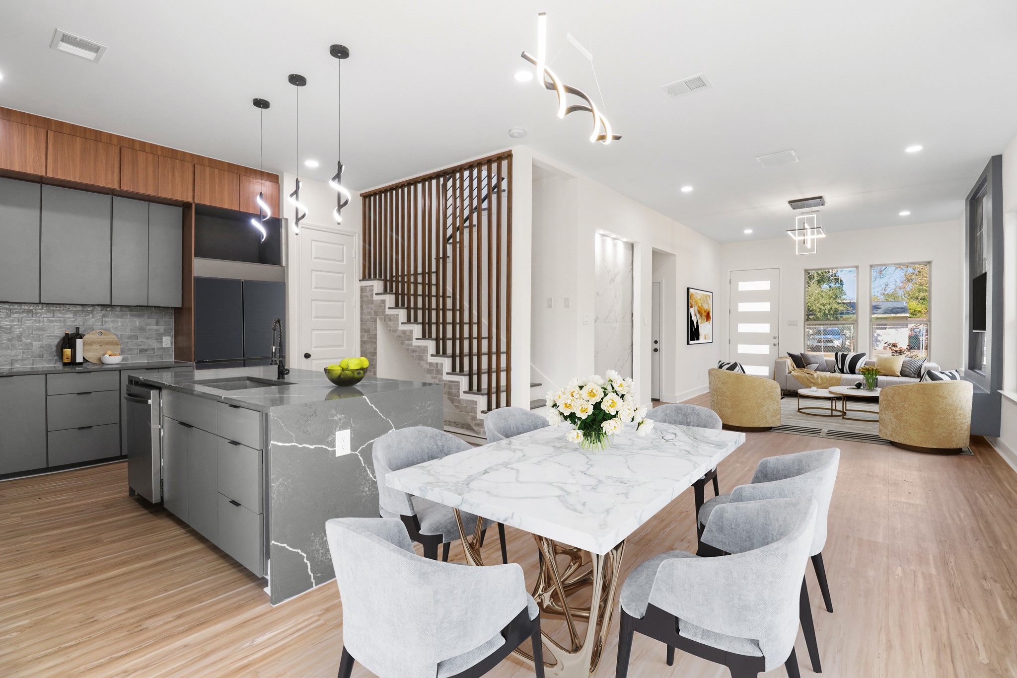 8046 Chateau Street Houston, TX 77028 - Photo 7 of 22 This modern open-concept space features a sleek kitchen with a large island, elegant dining area with a marble-top table, and a cozy living room with ample natural light. The stylish staircase adds a contemporary touch to the inviting layout.