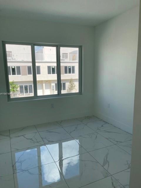 25822 Southwest 144th Court, Unit 25822 Homestead, FL 33032 - Photo 11 of 19 a view of an empty room with a window