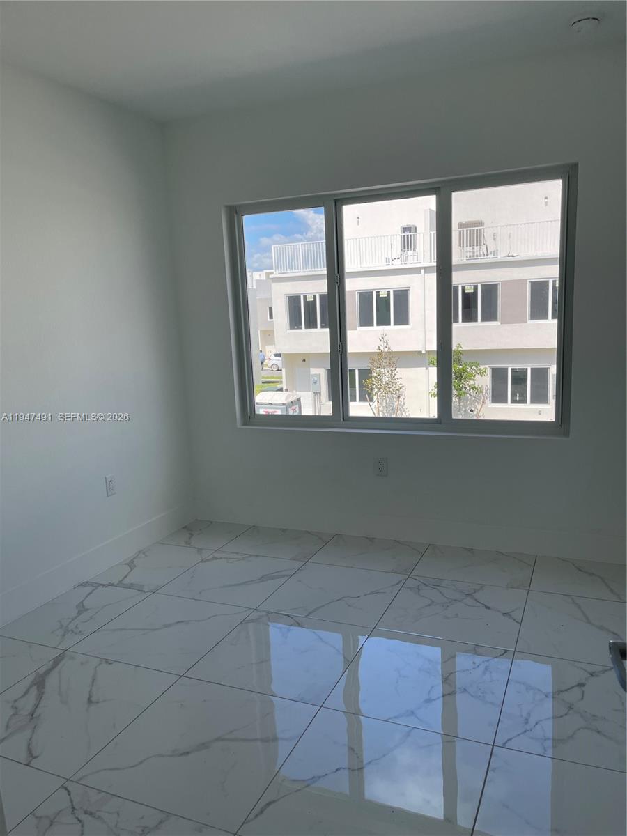 25822 Southwest 144th Court, Unit 25822 Homestead, FL 33032 - Photo 16 of 19 a view of an empty room with a window