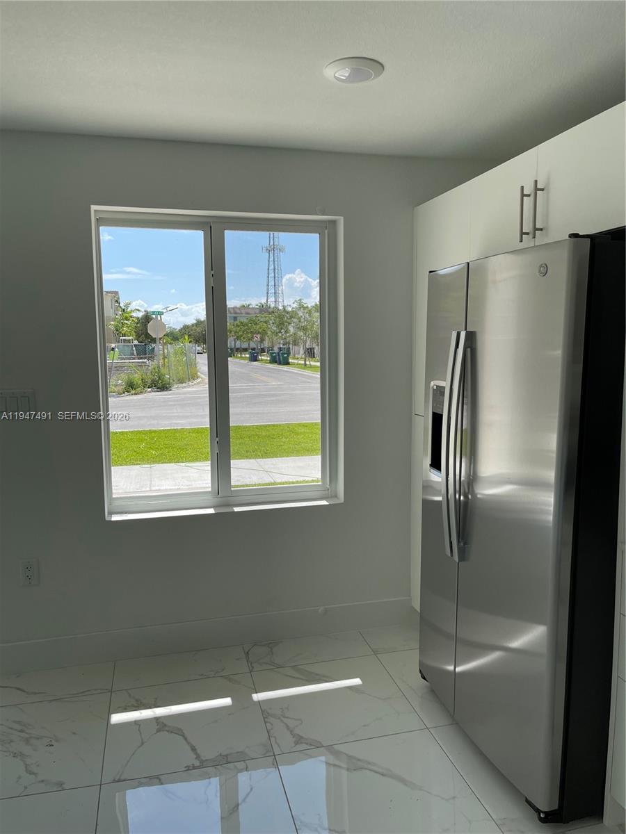 25822 Southwest 144th Court, Unit 25822 Homestead, FL 33032 - Photo 5 of 19 a view of a refrigerator in kitchen and a window