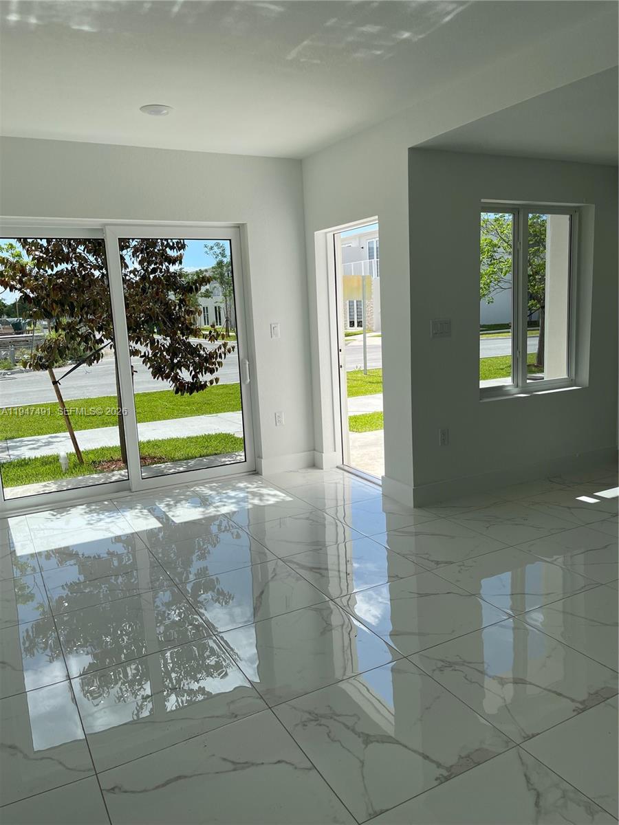 25822 Southwest 144th Court, Unit 25822 Homestead, FL 33032 - Photo 6 of 19 a view of an empty room with window