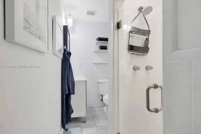 a bathroom with a shower and a toilet