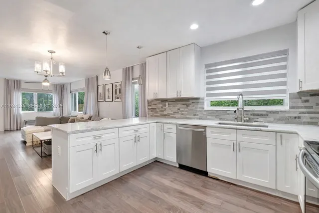 a kitchen with a sink cabinets and window