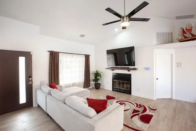a living room with fireplace furniture and a flat screen tv