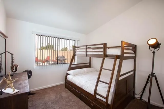 a bedroom with furniture and a window