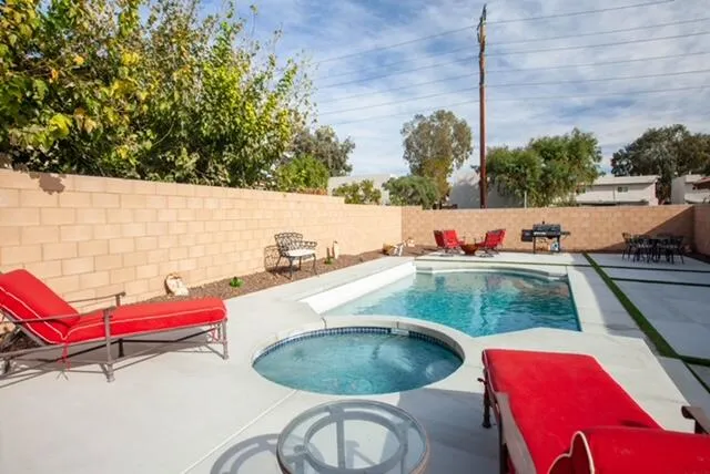 a backyard of a house with table and chairs