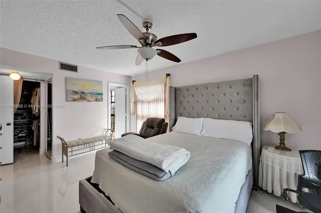 a view of walk in closet with clothes