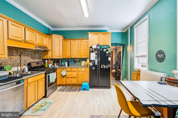 a large kitchen with lots of counter top space and stainless steel appliances