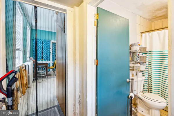 a view of a hallway with furniture and a window