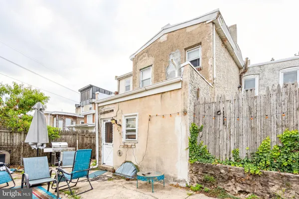 a view of a building with backyard and sitting area